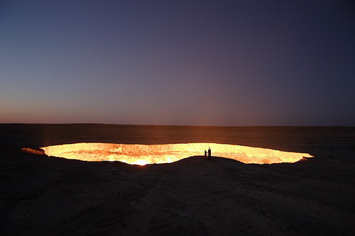 Darvaza Gas Crater at Night with Silhouettes of People