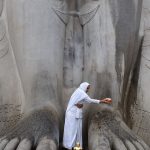 Jain Worshiper Does Abhishek of Feet of Bhagwan Bahubali Gomateswara at Shravanabelagola, Karnataka, India, Photo by Dey.sandip, Wikipedia